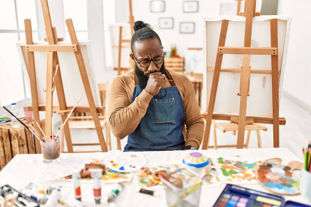 African american artist man at art studio feeling unwell and coughing as symptom for cold or bronchitis. health care concept.  - Foto, afbeelding