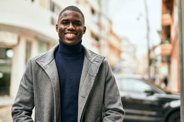 Young african american man smiling happy standing at the city - Photo, Image