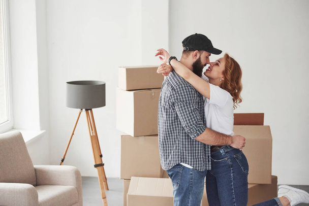 Closeness and love. Happy couple together in their new house. Conception of moving. - Fotoğraf, Görsel