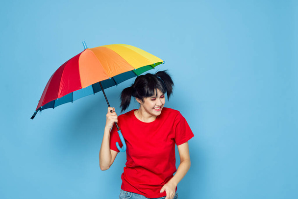 cheerful woman in red t-shirt rainbow color umbrella fashion - Foto, imagen
