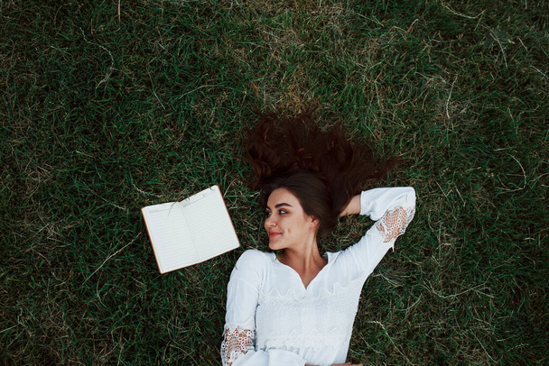 Rest and relaxation. Girl lying down on the green grass. - Fotografie, Obrázek