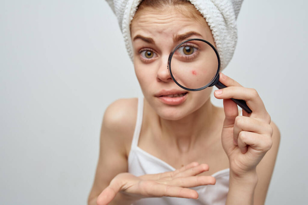 beautiful woman with a magnifying glass in hand cosmetology Studio - Photo, Image