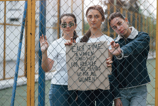 Quote on the paper. Group of feminist women have protest for their rights outdoors. - Foto, Imagen