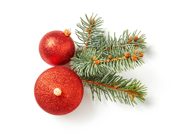 Fir tree branches and Christmas balls on white background - Фото, изображение