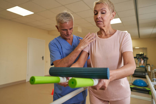 Mature woman during physical therapy in rehab center - Photo, Image