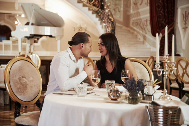 Ready for a kiss. Beautiful couple have romantic dinner in luxury restaurant at evening time. - Fotografie, Obrázek