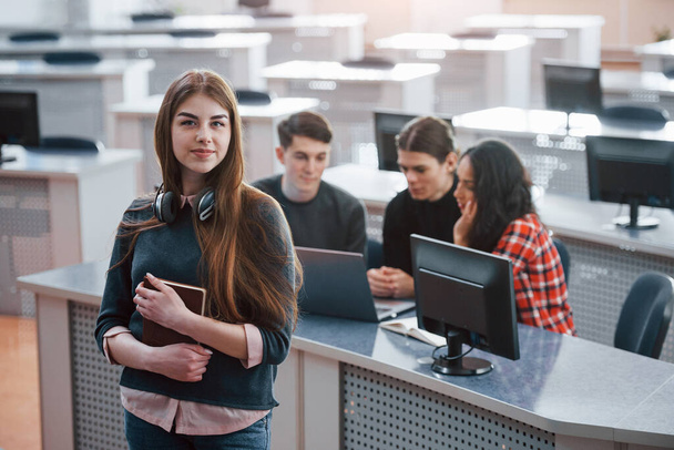 In front of collegues. Group of young people in casual clothes working in the modern office. - Zdjęcie, obraz