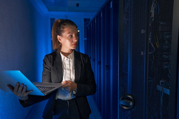 Photo of engineer businesswoman in network server room - Photo, Image