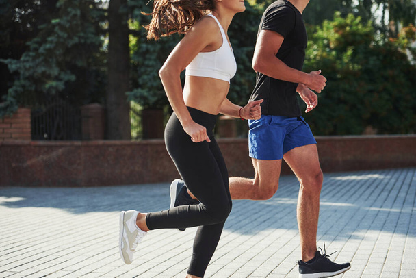 Man and woman have fitness day and running in the city at daytime. - Fotó, kép