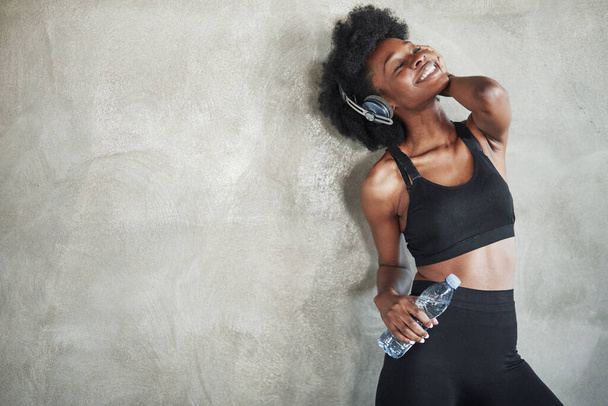 Feeling good. Portrait of african american girl in fitness clothes having a break after workout. - Photo, Image