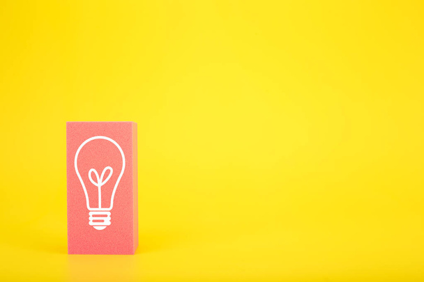 Concept of idea, creativity, start up or brainstorming. White drawn light bulb on pink rectangle against yellow background with copy space - Valokuva, kuva