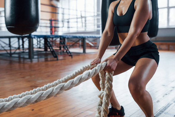 Productive exercise. Blonde sport woman with ropes in the gym. Strong female. - Zdjęcie, obraz