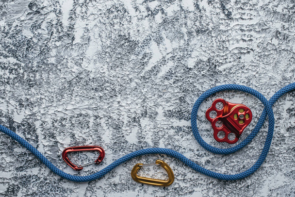Waiting for customer to buy it. Isolated photo of climbing equipment. Part of carabiner lying on the white and grey colored table. - Foto, immagini
