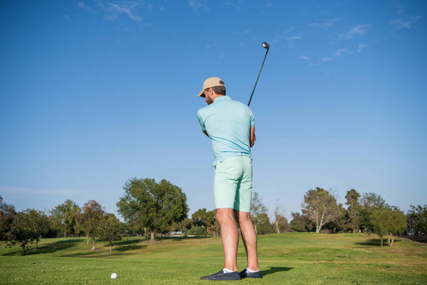 male golf player on professional golf course. portrait of golfer in cap with golf club. - Fotografie, Obrázek