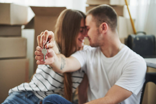 Holds keys of their new house. Successful people. Cheerful young couple in their new apartment. Conception of moving. - Foto, Imagen