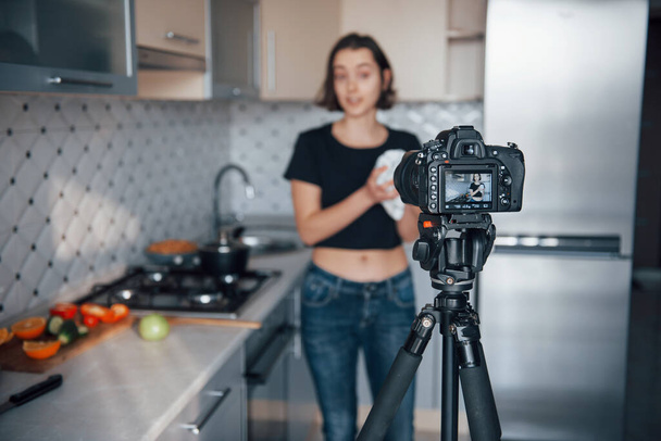 Attractive young woman in the frame. Girl in the modern kitchen at home at her weekend time in the morning. - Foto, Bild