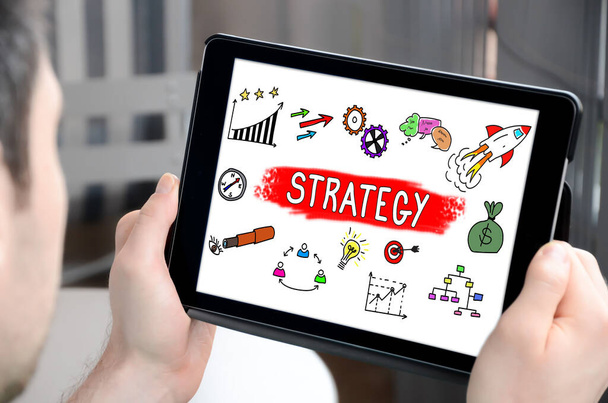 Man holding a tablet showing business strategy concept - Zdjęcie, obraz