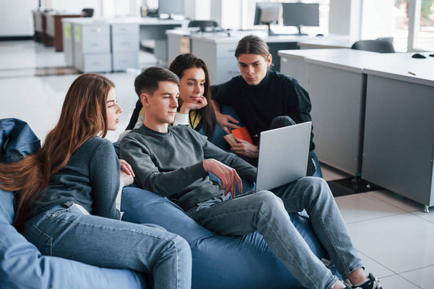 Process of work. Group of young people in casual clothes in the modern office. - Valokuva, kuva