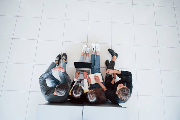 Typing on keyboard. Top view of young people in casual clothes working in the modern office. - Fotografie, Obrázek