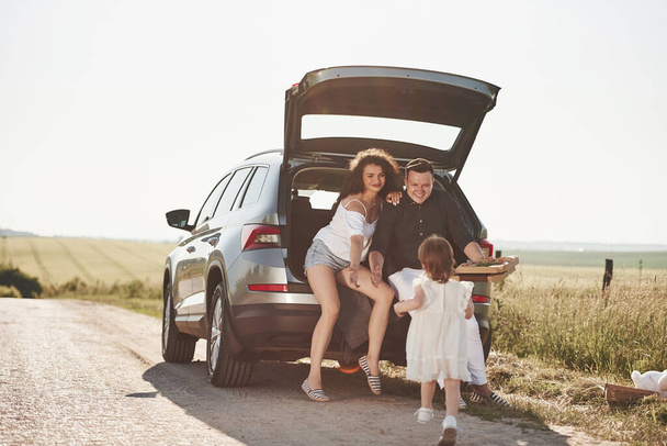 Running to parents. Beautiful people is in the modern car at their weekends. - Fotó, kép