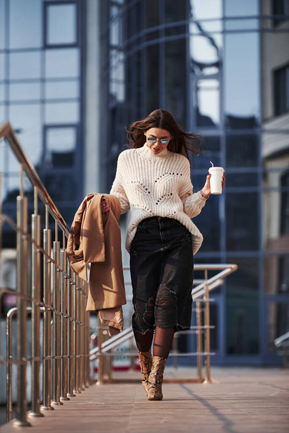 Outdoors fashion wear. Young beautiful girl in warm clothes have walk in the city at her weekends time. - Photo, image
