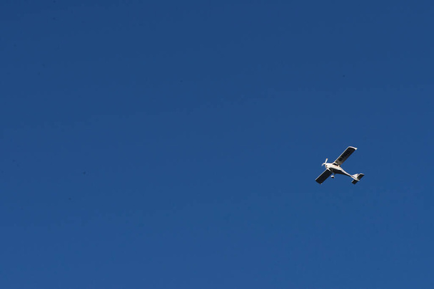Doppeldecker fliegen hoch in den blauen Himmel an einem sonnigen Tag. Geschwindigkeit und Energie. - Foto, Bild