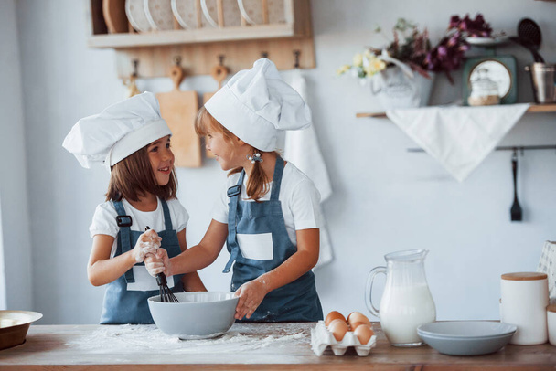 Family kids in white chef uniform preparing food on the kitchen. - Φωτογραφία, εικόνα