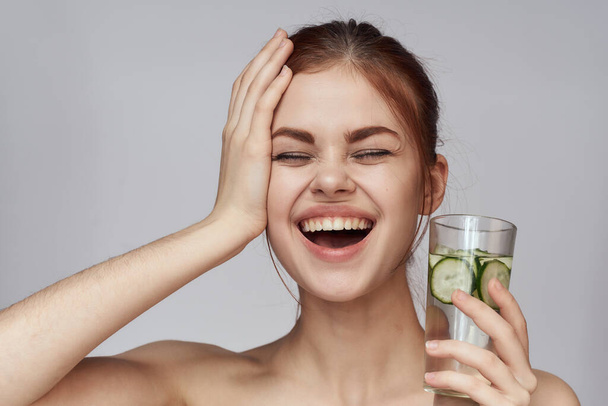 woman with cucumber drink health vitamins close-up - Photo, image
