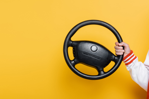 cropped view of middle aged man holding steering wheel on yellow - Фото, зображення