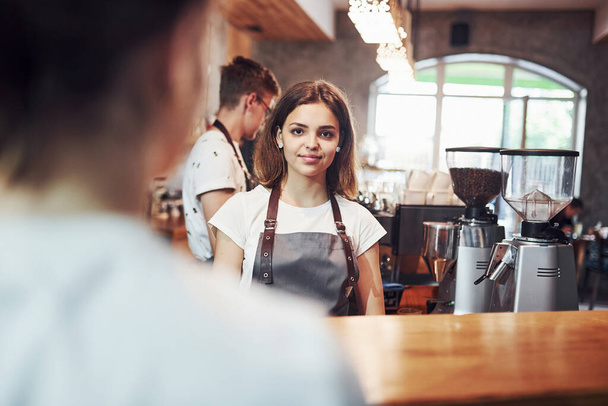 Customer service. Two young cafe workers indoors. Conception of business. - Foto, imagen