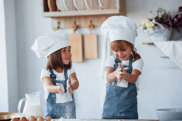 Family kids in white chef uniform preparing food on the kitchen. - Valokuva, kuva