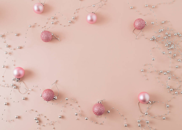 New Year Layout with a Christmas balls on pink background with free space in middle. - Photo, Image