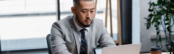 asian businessman in formal wear working on laptop in office, banner - 写真・画像