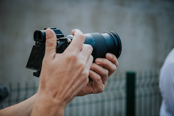 A Closeup of a camera and a male hands taking shots - 写真・画像