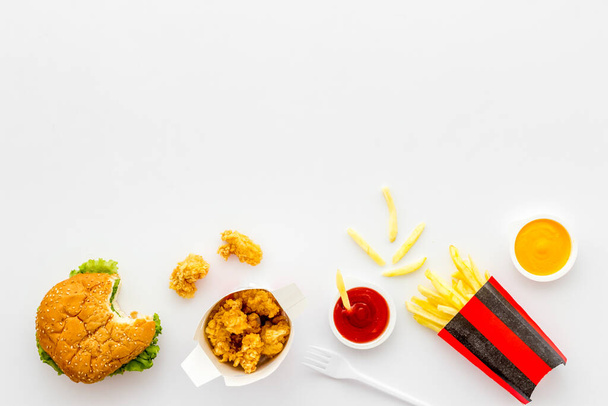 Flat lay of fat fast food - burger chicken nuggets and french fries - Valokuva, kuva