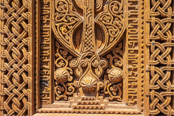 Ancient traditional carved khachkar or cross-stone near Geghard Cathedral, close-up view. Armenian heritage and Art - Photo, Image