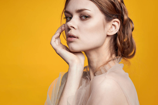 pretty woman gesture hands cosmetics fashion hairstyle posing yellow background - Foto, imagen