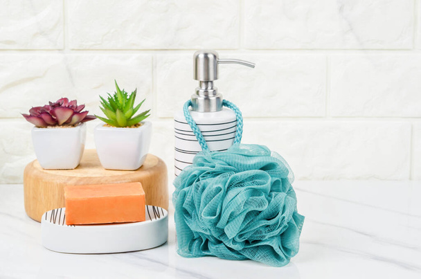 Shower sponge and shampoo pump bottle inside a bright bathroom background. - Fotografie, Obrázek