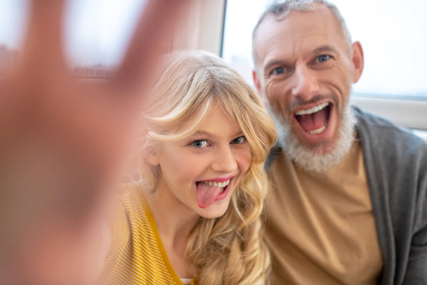 A man and his daughter feeling joyful and having fun - Фото, зображення