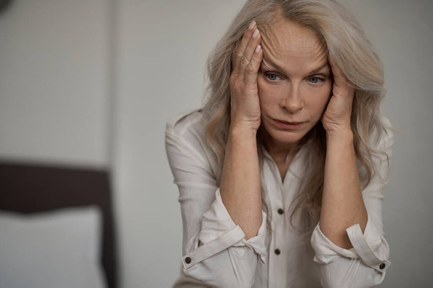 Despondent blonde mature woman suffering from loneliness - Fotó, kép