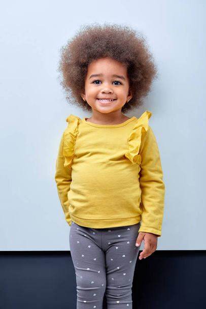 Adorable multiracial little girl with a funny expression isolated on white background - Valokuva, kuva