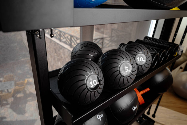 Balls and foam roller sport equipment in a gym - Photo, image