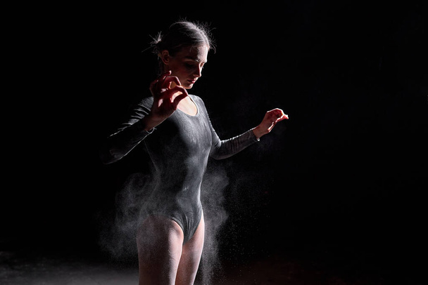 young slim caucasian ballet dancer women wearing black bodysuit, sensually poses - Zdjęcie, obraz