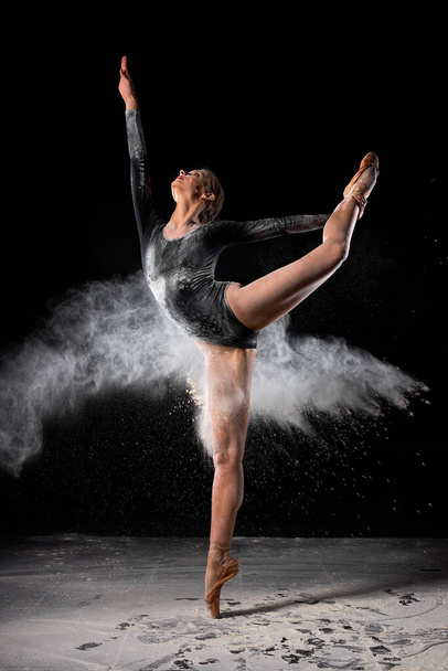 Dancing in flour concept. Young beautiful female adult woman dancer in dust - Фото, зображення