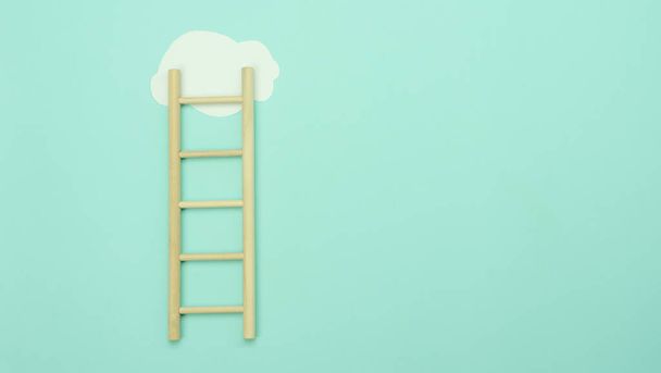 Top view wooden ladder with cloud same as step stair on  paper background, Business growth up and successful concept. copy space for text. Abstract Success stock market . management achievement. - Photo, image