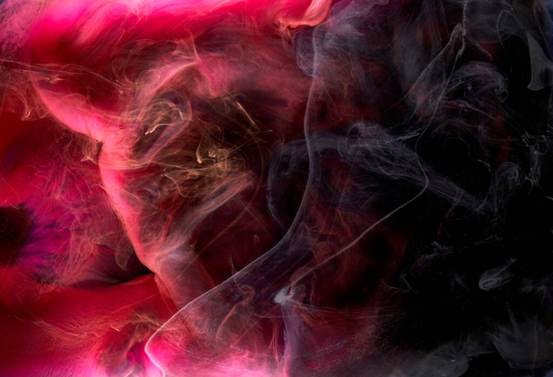 Red black pigment swirling ink abstract background, liquid smoke paint underwater - Foto, Imagem