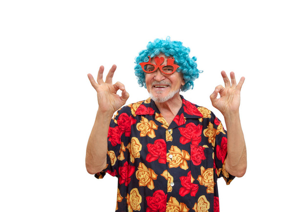 A cheerful and extravagant grandfather in a wig entertains merrily, dances and shows o kay! - Photo, Image