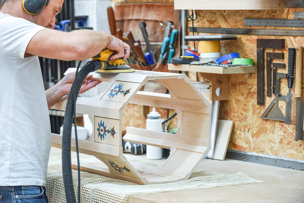 A man is making bespoke furniture in a woodwork workshop showing the construction process - Photo, Image