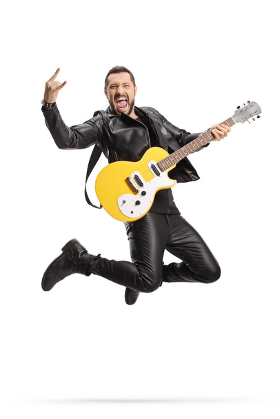 Male rock musician with an electric guitar jumping isolated on white background - Fotografie, Obrázek