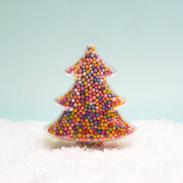 Beautiful colorful christmas tree ornament winter inspired concept. Polar light and snow white background. - Zdjęcie, obraz